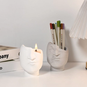 Minimalist face sculpture storage cups used as candle holder and desk organizer