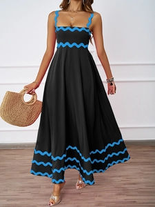 Detail of black summer maxi dress featuring elegant blue rickrack wavy trim on the straps
