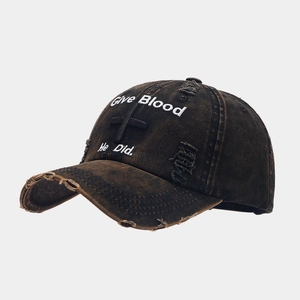Detailed view of washed vintage baseball cap with religious cross and Give Blood embroidery
