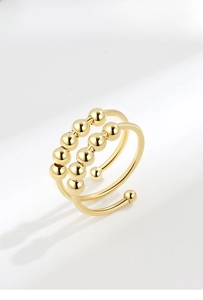 Detail of a double-layer gold spinning ring with ten movable beads for anxiety relief