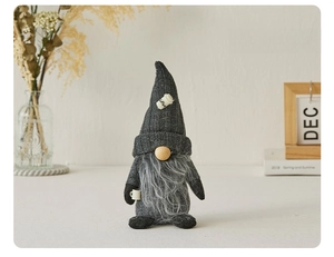 Close-up of a handmade coffee gnome plush toy with a gray beard and coffee cup detail