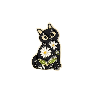 Detailed view of black cat enamel pin with white daisy patterns and gold metal edges