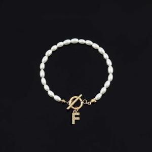 Elegant pearl bracelet with golden OT clasp and sparkling crystal letter F pendant