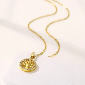 Golden Tree of Life pendant necklace with pavé zircons on elegant white texture
