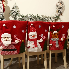 Close-up of Santa, Snowman, and Reindeer linen chair covers for festive dining decor