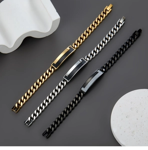 Detailed view of three Cuban link bracelets with carbon fiber ID plates in gold, silver and black