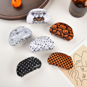Detailed set of six Halloween hair claws with pumpkin, spider web, and skull patterns