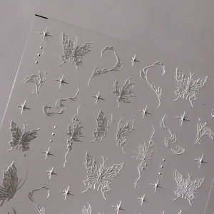 Embossed silver butterfly and star nail art stickers with 3D metallic texture effects