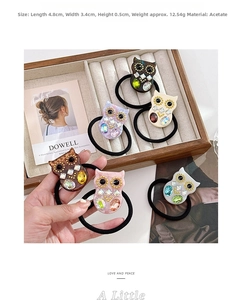 Close-up of owl acetate hair ties with sparkling rhinestones in six assorted colors