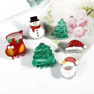 Glittery Christmas hair claw clips featuring snowman, Santa Claus and festive tree motifs
