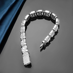 Macro shot of silver square link iced-out Cuban bracelet with cubic zirconia detailing