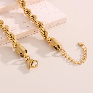 Detail of golden twist rope chain necklace featuring a lobster clasp and extension chain