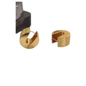 Polished chunky gold hoop earrings with horizontal grooved texture on a white background