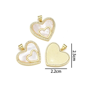 Macro view of gold plated heart pendant with shell inlay and zircon details and dimensions