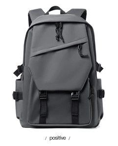Front view of a dark gray water-resistant laptop backpack with geometric flap and buckles