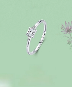 Macro shot of S925 sterling silver ring with square-cut zircon on floral background
