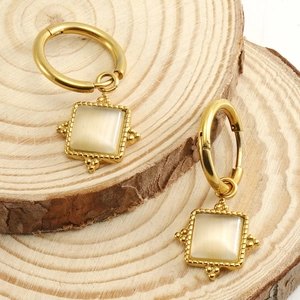 Elegant 18K gold-plated square cat eye stone drop earrings on natural wood stand