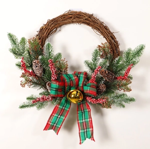 Christmas pine cone wreath with plaid bow, golden bells and red berries on rattan base
