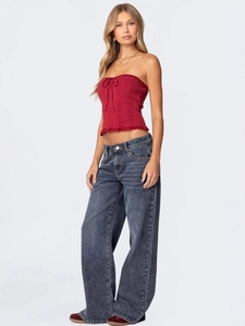 Women's retro wide-leg denim jeans with a red tube top and bow in a stylish street look