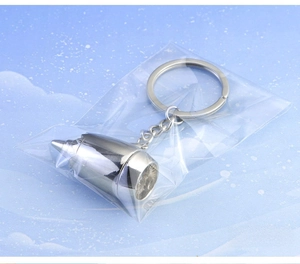 Close-up of a silver airplane turbine engine keychain with polished finish in OPP bag