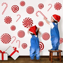 Children decorating white wall with peppermint candy and candy cane Christmas wall decals