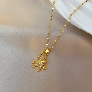 Detailed macro view of gold unicorn pendant with shimmering micro-pave crystals on silk