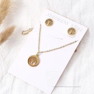 Detail of 18k gold-plated stainless steel tree of life necklace and stud earrings set