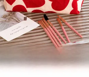 Detailed view of 6-piece pink makeup brush set with heart pattern travel storage bag