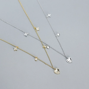 Close-up of gold and silver S925 sterling silver heart necklaces with sparkling zircons