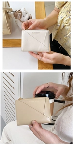 Detail of minimalist women's wallet with slanted front pocket and gold classic star text