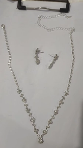 Detailed view of silver zircon flower bridal necklace and water drop fringe earrings set