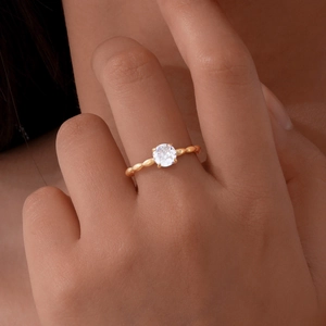 Gold Mobius stainless steel ring for women with single zircon stone shown on finger
