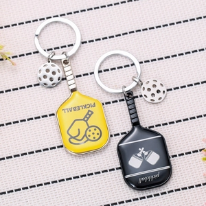 Pickleball paddle keychain set in yellow and black zinc alloy with miniature ball charms
