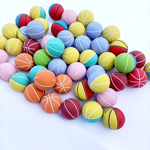 Macro view of colorful mini 6cm bouncy basketballs in a bulk stack on white background