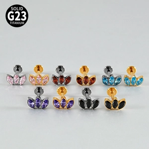 Close-up of G23 titanium labret studs with three marquise zircon and opal stones