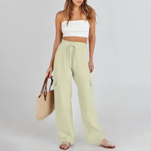 Detail of high-waist linen cargo pants showing drawstring waist and side patch pockets