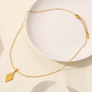 Detail of 18K gold plated stainless steel necklace with sun moon star diamond pendant