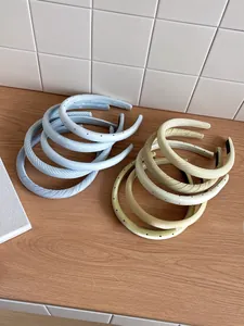 Close-up of padded headbands with yellow and blue patterns on a wooden table