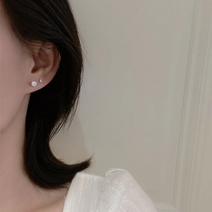 Elegant 925 silver stud earrings with round white zircon stones worn by a model