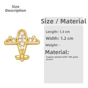 Macro detail of airplane earring featuring 18K gold plating and cubic zirconia
