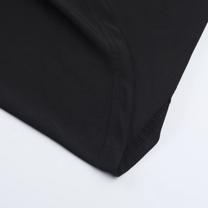 Close-up of double-stitched seams and fine fabric texture on a black bodycon dress