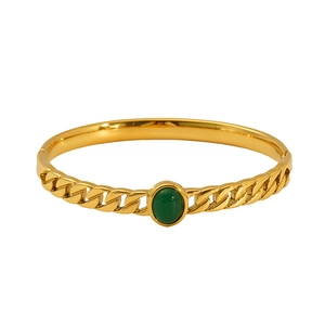 Luxurious gold-plated Cuban chain bracelet featuring a green oval stone on white background