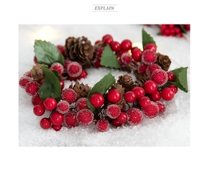 Macro shot of artificial red berries and pine cones on a snowy Christmas candle ring