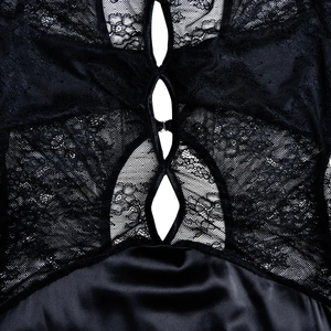 Detailed view of the black lace and satin splicing on a sexy hollow-out dress for women