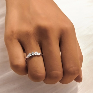 Macro shot of S925 sterling silver ring with five marquise-cut crystals on finger