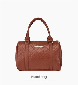 Detailed view of caramel quilted handbag with diamond stitching and gold metal logo