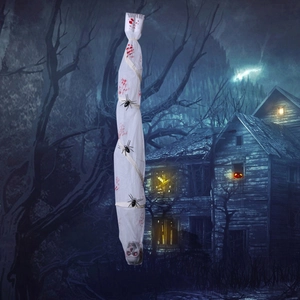 Close-up of hanging Halloween skull mummy with blood stains and glowing red eyes