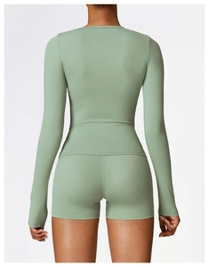 Back view of mint green long sleeve yoga top and high waist shorts set with slim fit