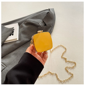 Mini yellow glossy heart-style square crossbody bag with elegant gold chain strap