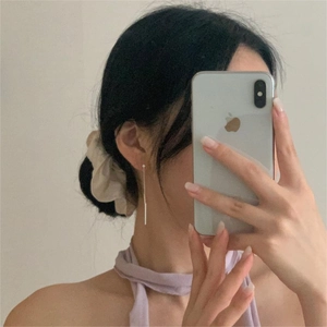 Detail of 925 sterling silver minimalist long bar drop earrings in a mirror selfie